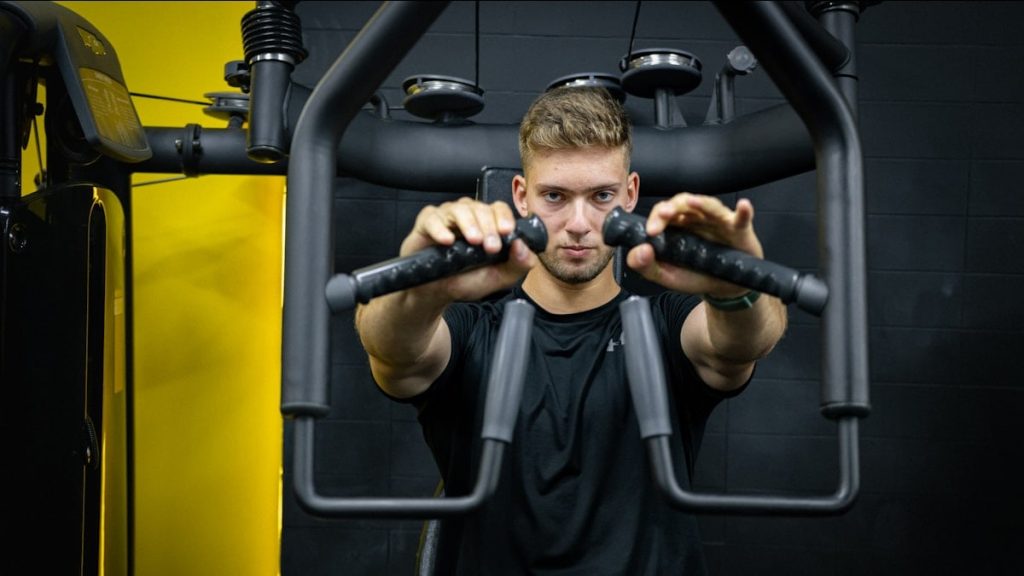 a man is doing exercises on a machine